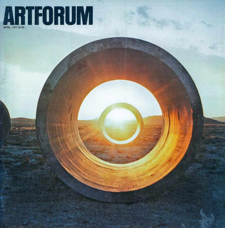 Cover of Artforum magazine with black logo in top left and image of circular concrete tunnels with sun setting in background.