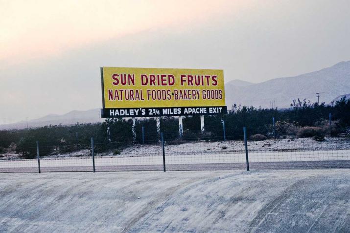 a sign that says "Sun Dried Fruits" above a concrete culvert