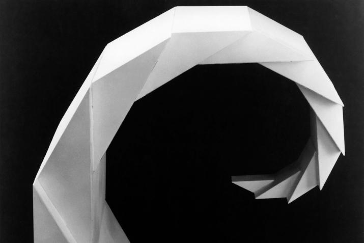 white geometric faceted spiraling sculpture with black background