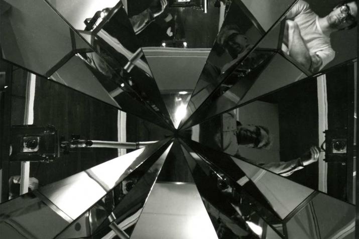 Black and white image of angular reflections converging at a center point