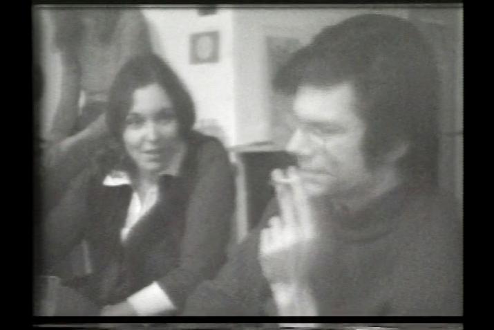 black and white, a young man and woman seated next to each other in conversation