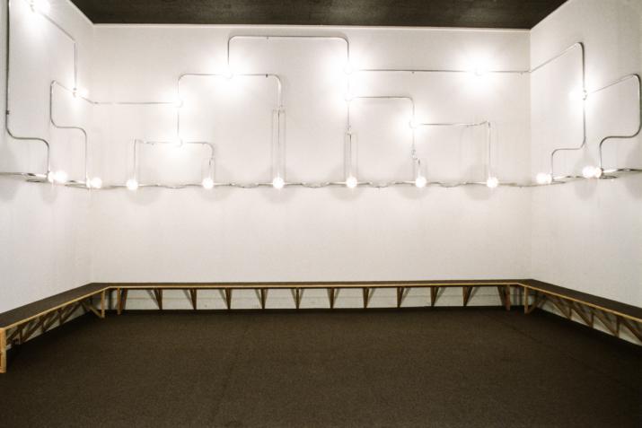 Nancy Holt's sculpture Electrical Lighting for Reading Room made of lightbulbs and conduit along three walls