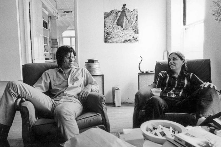 Nancy Holt and Robert Smithson seated on chairs in their NYC loft