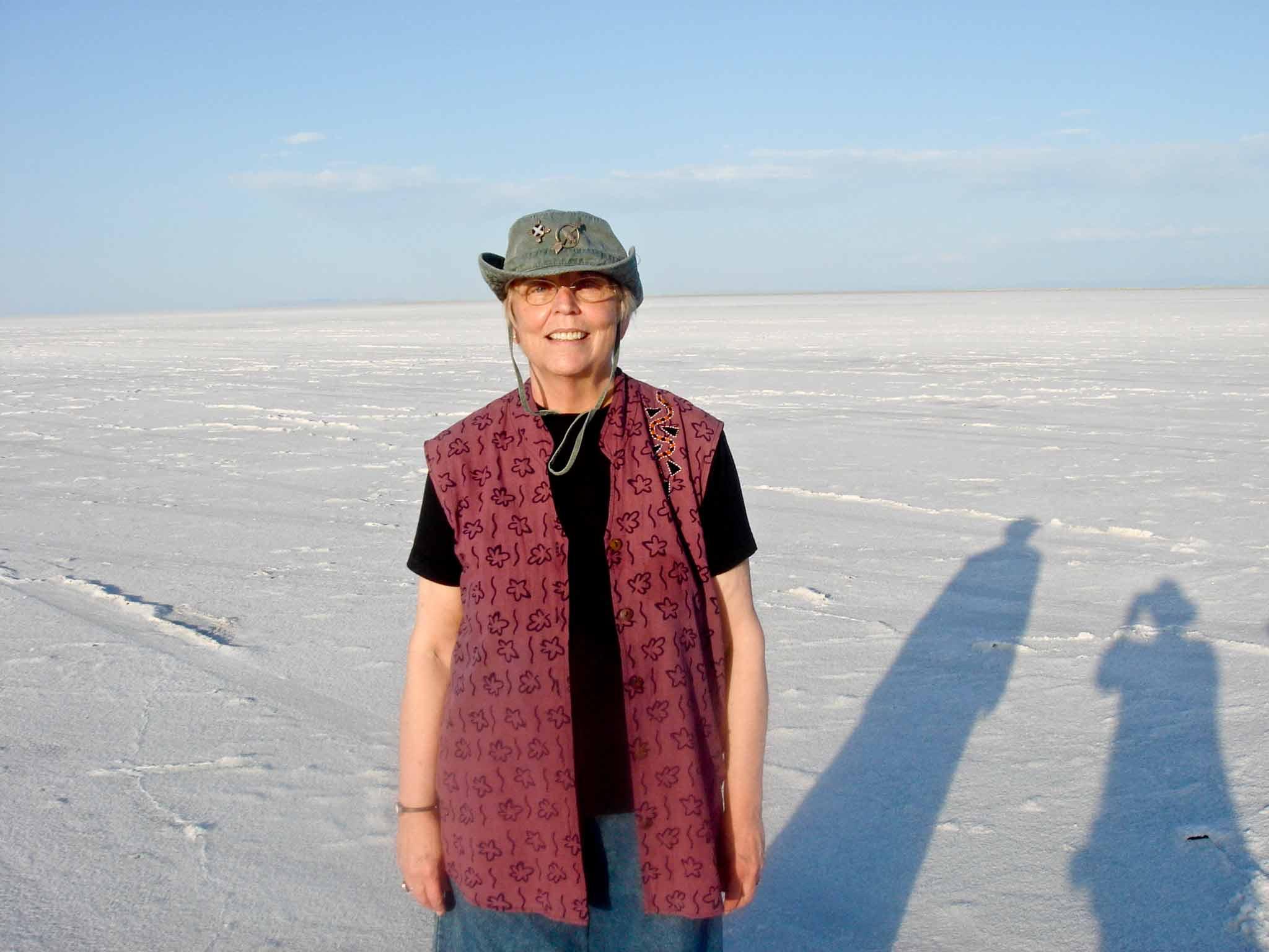 Nancy Holt stranding alone with the Salt Flats of Utah in the background.