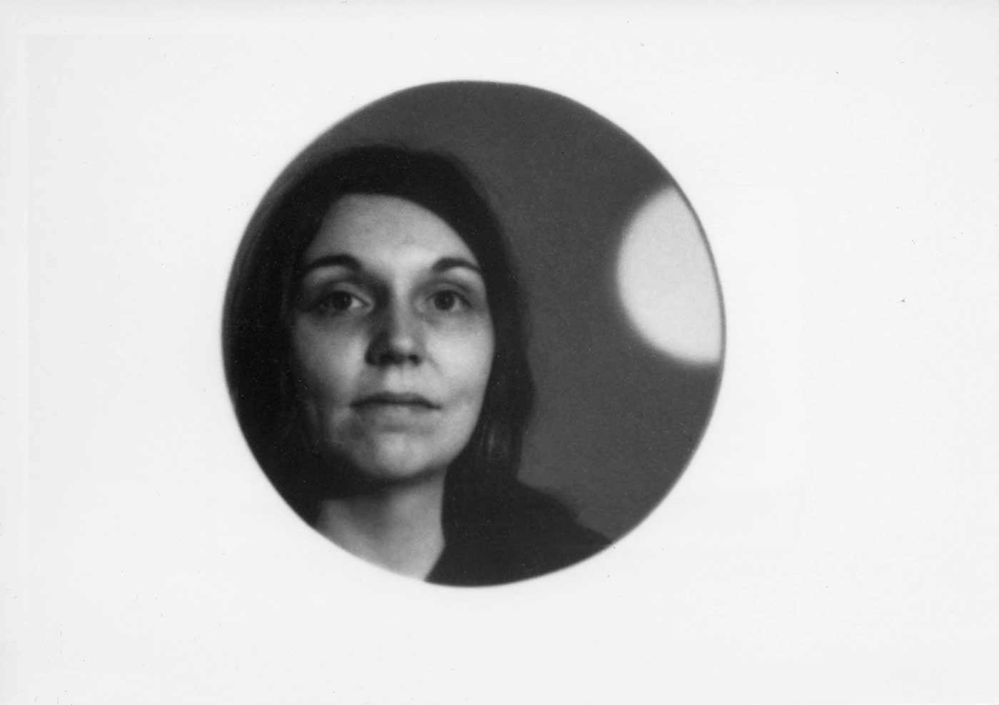 Nancy Holt framed by a circular hole in her installation Holes of Light, January 1973.