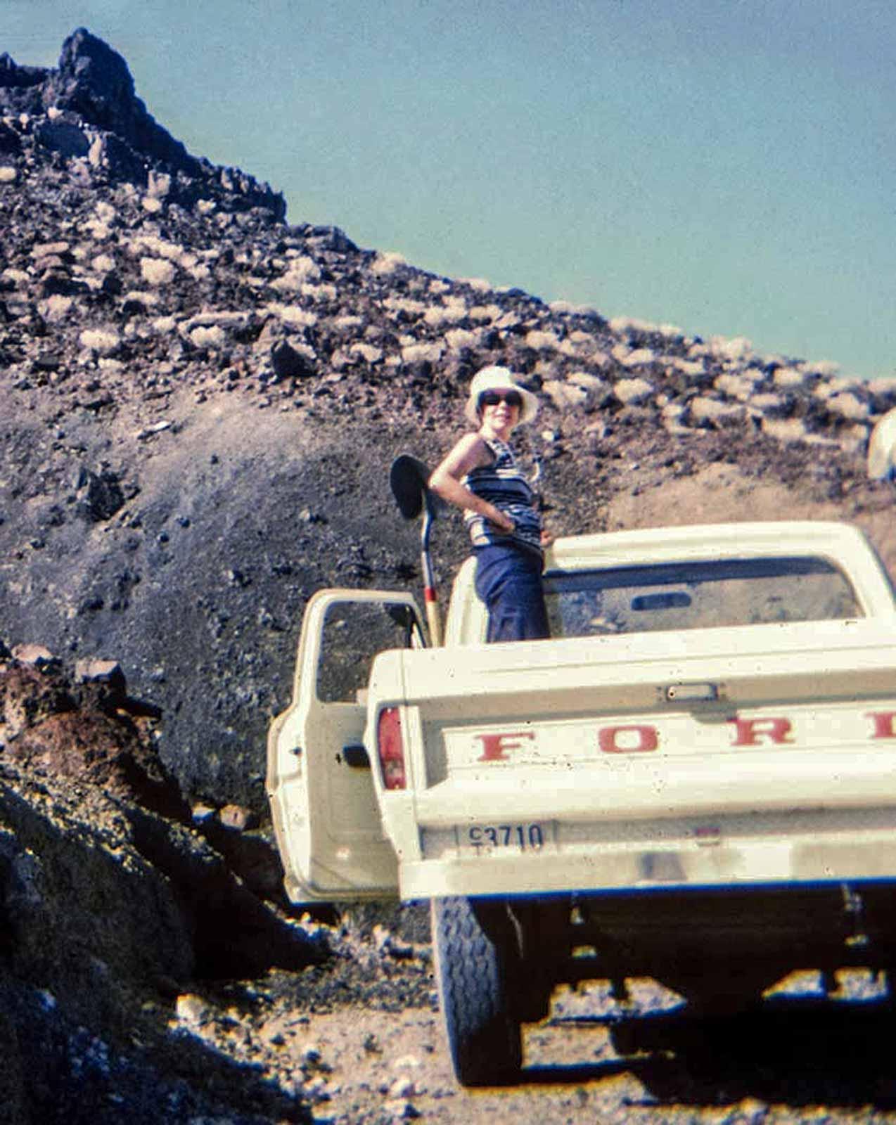 Holt standing in the back of a Ford pick up truck in the Utah desert. Photograph by Michael Heizer.