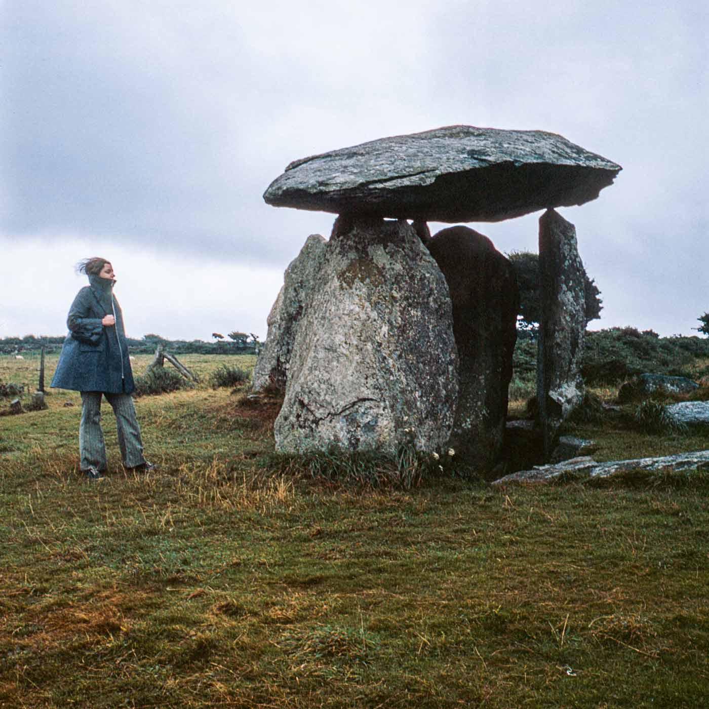 Nancy Holt standing next to an arch shaped dolmen at Pembrokeshire Coast National Park, Wales. October 1969