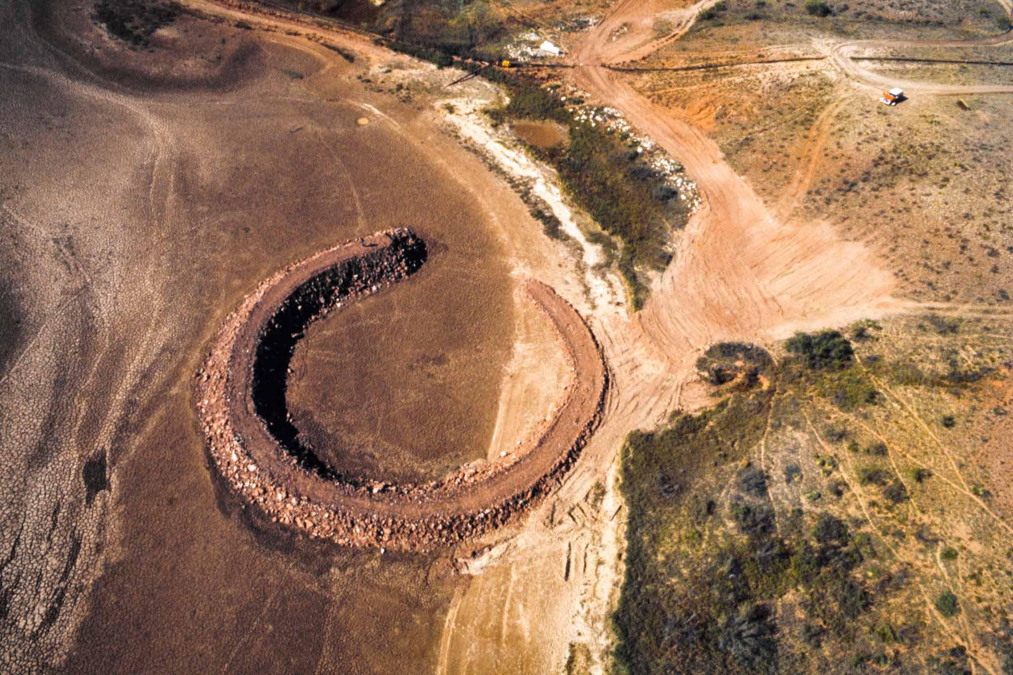 The earth and rock circle of Smithson's Amarillo Ramp spiraling out of the earth.
