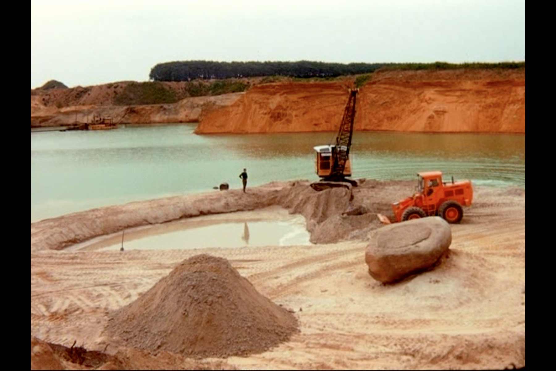 A still image from the film Breaking Ground: Broken Circle/Spiral Hill. Broken Circle during construction, 1971. Film footage by Nancy Holt.