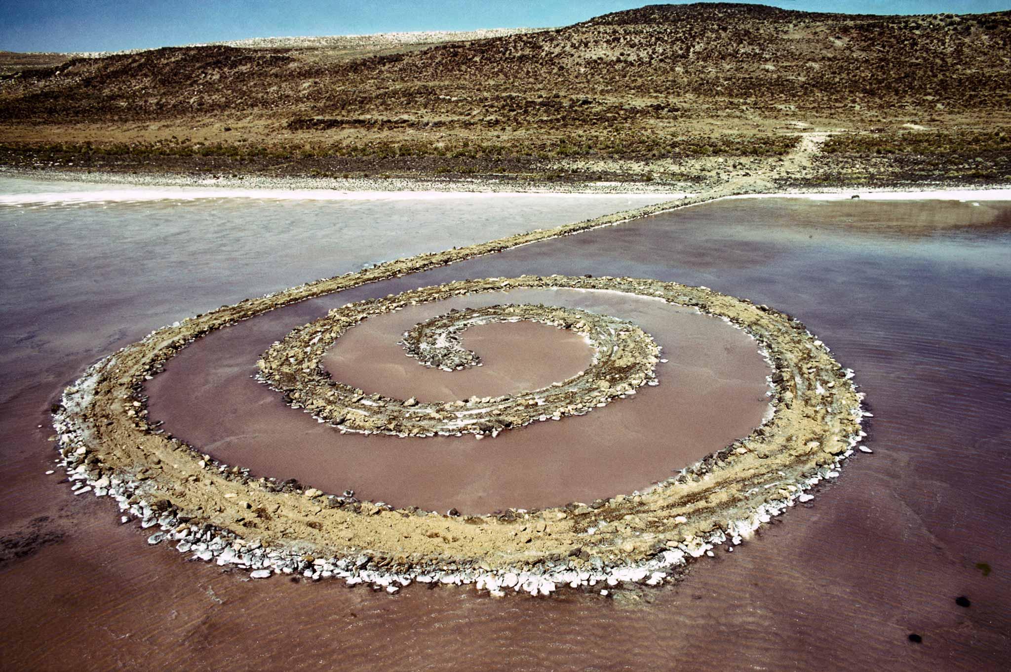 Robert Smithson's Spiral Jetty made of rock and salt in the Great Salt Lake  photographed from the air.