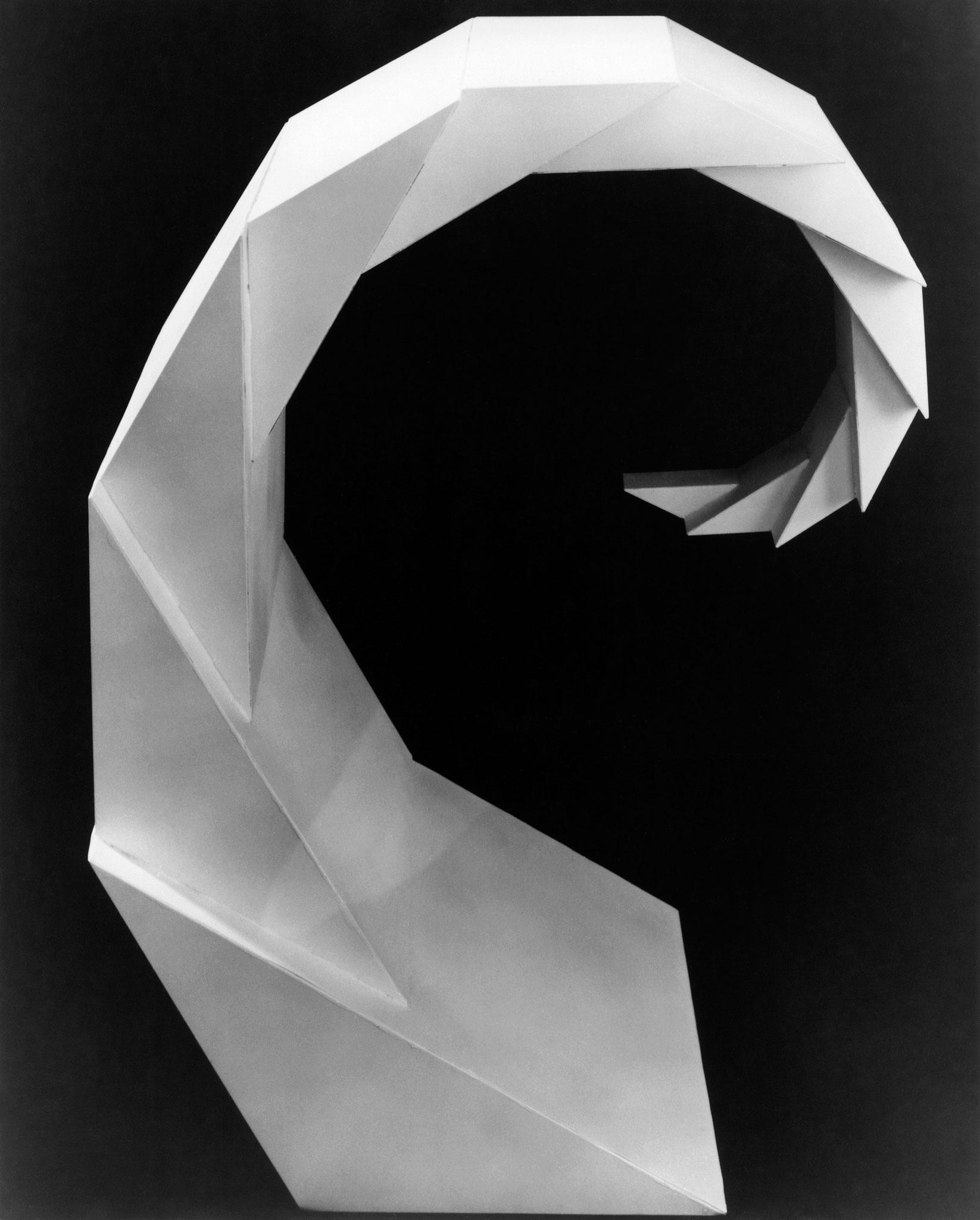black and white image of geometric, faceted spiraling sculpture 