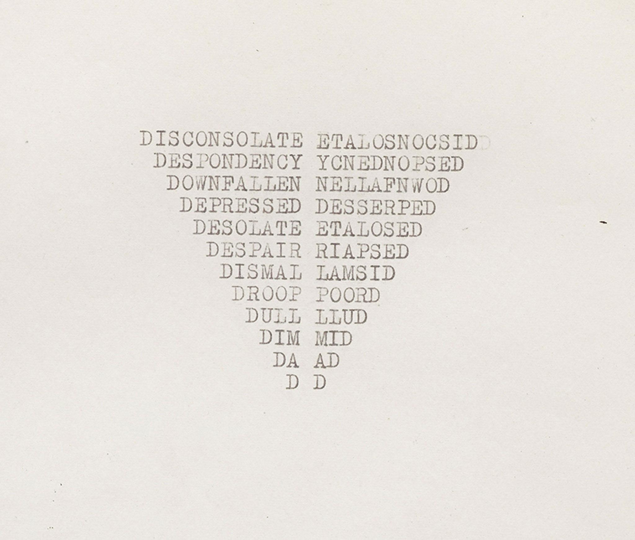 a yellowing piece paper with words typewritten in the shape of an inverted triangle in the center of the paper