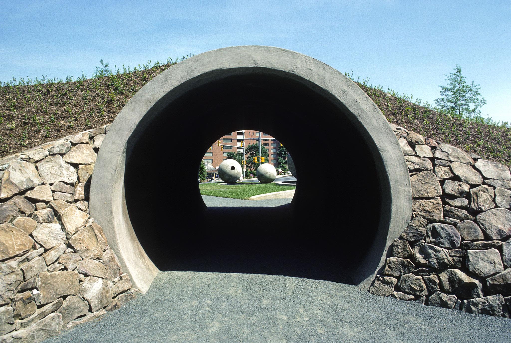 a large circular tunnel underneath a berm 